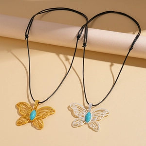 Hollow butterfly pendants with turquoise stones on black wax cords in gold and silver