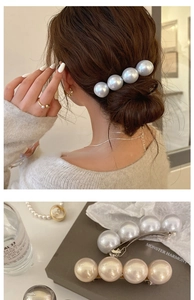Detail view of large pearls hair clip with matching pearl ring and gold earrings