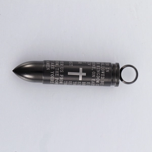 Detail of black bullet pendant with engraved cross and The Lord's Prayer text