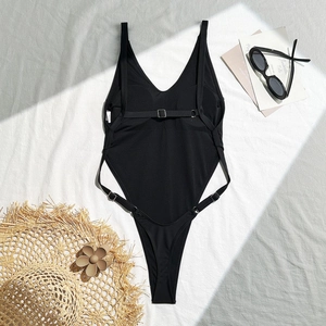 Flat lay of black deep V-neck one-piece swimsuit with high-cut leg and strappy back details