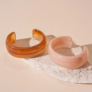 Retro acrylic open bangles with marble texture in amber and pink on stone base