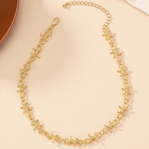 Detail of golden thorn wire necklace with lobster clasp and adjustable extension chain