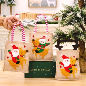 Linen Christmas gift bags with Santa and snowman designs and striped handles