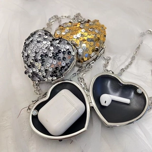 Detail of sequined heart-shaped evening bags in gold and silver with chain straps