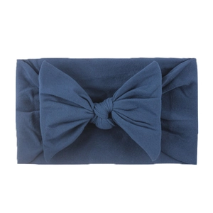 Close-up of navy blue baby headband with a soft nylon bow and wide elastic texture