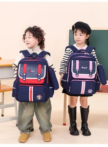 Detail view of boys and girls wearing ergonomic backpacks in navy blue in a classroom setting