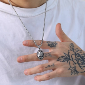 3D stainless steel football pendant necklace for men worn over a white street style t-shirt