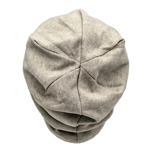 Detailed top view of light gray knitted beanie showing textured fabric and pleated crown