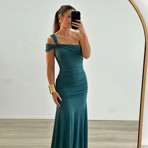 Détail d'une robe bleu canard à une épaule avec design plissé et fente latérale