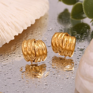 Detailed macro shot of 18K gold plated triple layered ribbed texture hoop earrings