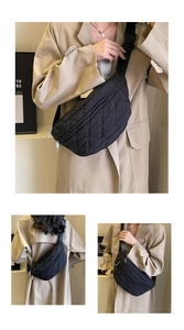 Detailed view of black quilted crossbody chest bag with adjustable strap and silver zipper
