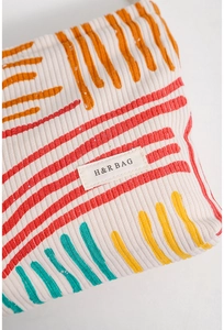 Detail of floral corduroy makeup bag featuring high-quality fabric texture and H&R BAG label