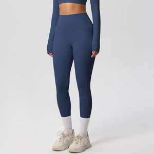 Detail of high-waisted dark blue yoga leggings and matching long sleeve crop top