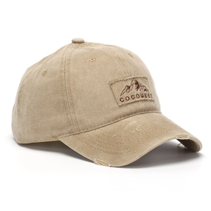 Macro detail of khaki washed cotton baseball cap with distressed holes and brand patch