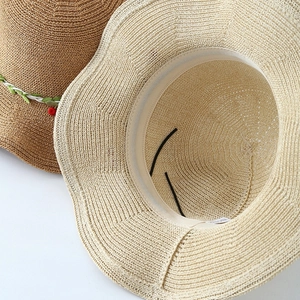 Women's woven straw sun hat set in beige and brown with adjustable strap and leaf trim