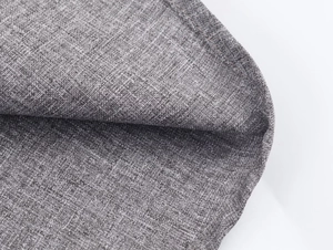 Macro view of grey textured fabric weave with precise double-stitched edge seams