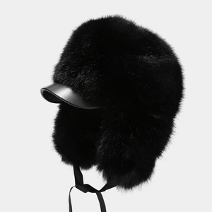 Close-up of black faux fur trapper hat with high-density plush and shiny leather brim