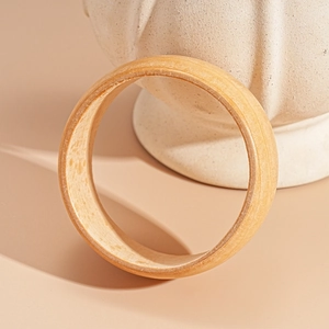Detailed view of vintage wooden texture on minimalist geometric open bangle bracelet