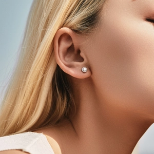 Elegant s925 silver round moissanite stud earrings on female model in natural light