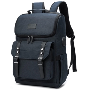 Close-up of dark blue Oxford backpack featuring black leather straps and a built-in USB port