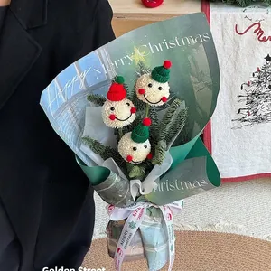 Creative Christmas bouquet featuring cute snowman plush toys and festive evergreen branches