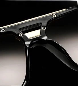 Macro detail of gold metal bar with precision screws on square frame sunglasses