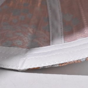 Macro shot of baseball cap inner sweatband and orange gold silk jacquard fabric