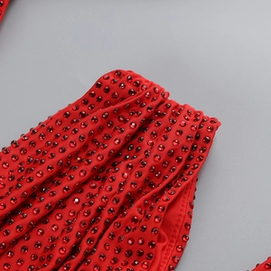 Macro view of glittering red rhinestones on luxurious evening dress fabric