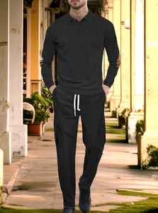 Close-up of black men's knit polo set showing vertical ribbed texture and cargo pockets