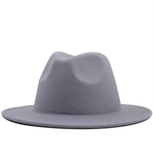 Detailed close-up of a grey wool fedora hat with a flat brim and classic pinched crown
