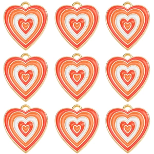 Close-up of nine heart-shaped enamel charms with colorful orange and red gradients