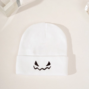 White knitted Halloween beanie featuring a black embroidered pumpkin expression