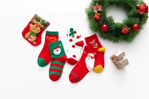 Detailed close-up of five pairs of festive cotton Christmas socks with holiday patterns