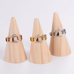 Hollow chain rings in rose gold, gold, and silver with cubic zirconia on wooden displays