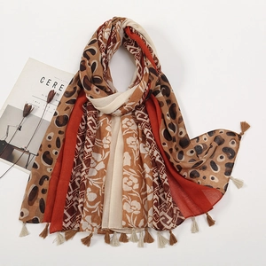 Bohemian voile scarf featuring vintage geometric prints and tassels in warm orange tones