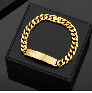 Detail of a 18K gold-plated Cuban chain bracelet with three diamonds in a black gift box