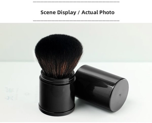 Detail of retractable makeup brush with synthetic bristles and black protective cap