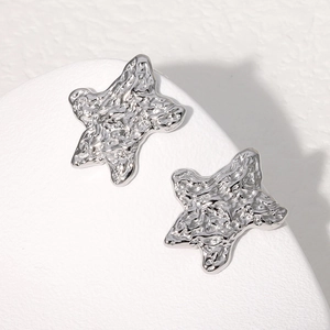 Modern silver stainless steel star earrings with irregular lava texture finish