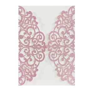 Macro view of pink glitter laser cut invitation cover with intricate floral patterns