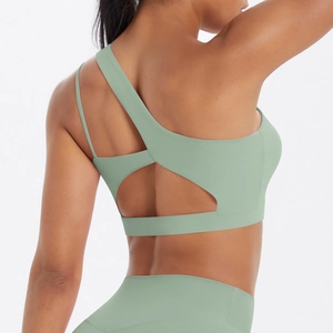 Sage green one shoulder sports bra featuring asymmetric strap and cutout back design