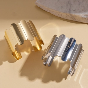 Irregular geometric wavy cuff bracelets in gold and silver finish with metallic texture