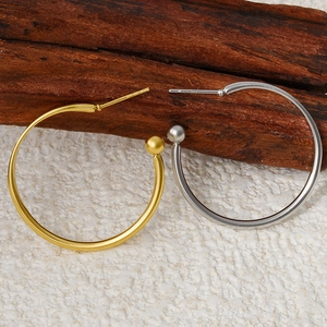 Macro shot of 304 stainless steel hoop earrings with sphere beads in gold and silver