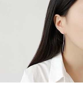 Minimalist S925 sterling silver linear drop earrings on model in a sleek profile view