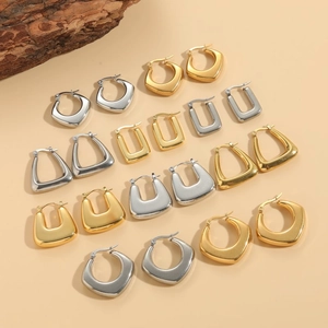 Minimalist geometric hoop earrings in gold and silver finish with brushed metal texture