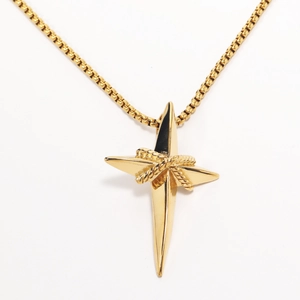 Macro detail of a golden stainless steel star pendant with twisted rope texture on box chain