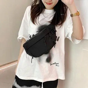 Minimalist black nylon crossbody chest bag for men and women shown on model