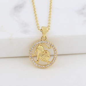 Detail of gold Leo constellation pendant with hollow lion and sparkling rhinestones