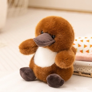 Close-up of soft brown plush platypus toy with detailed furry texture and stable sitting pose