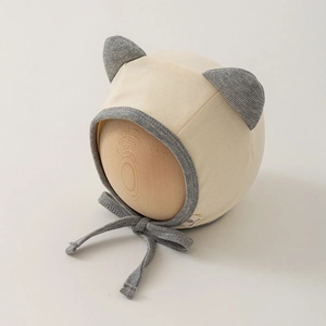 Detailed view of rib-knit newborn hat with cat ears and adjustable chin straps