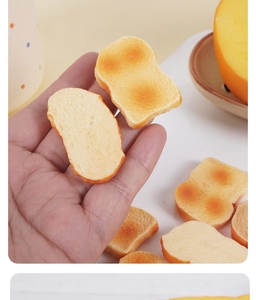 Detailed macro view of a heart-shaped miniature toasted bread model held in a hand